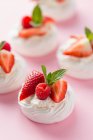 Mini pavlovas with whipped cream and berries — Stock Photo