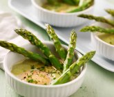 Soup with green asparagus and eggs — Stock Photo