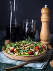 Raw salad with walnuts and cheese drizzled with balsamic glaze — Stock Photo