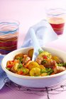 Colorful roast potatoes with peas and peppers — Stock Photo