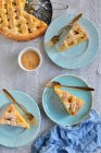 Шматочки яблучного пирога на тарілках з виделками та цукровим порошком — стокове фото