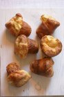 Fresh baked croissants on white wooden background — Stock Photo