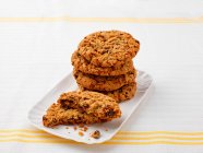 Oatmeal cookies with raisins on white plate — Stock Photo