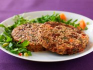 Beetroot and cabbage fritters with rocket salad — Stock Photo