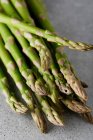 Fresh green asparagus on a dark background — Stock Photo