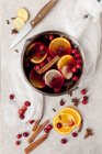 Non-alcoholic mulled wine with cranberries, orange slices and spices — Stock Photo