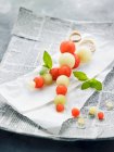 Melon skewers on a paper napkin — Stock Photo