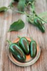 Fresh green and purple eggplant on a wooden background — Stock Photo