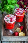 Strawberry lemonade in two glasses with straws — Stock Photo