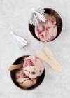 Chocolate and blackberry ripple ice cream with cocktail umbrellas in ice cream cups (top view) — Stock Photo