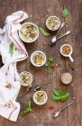 Homemade hummus with spices and herbs on a wooden background — Stock Photo