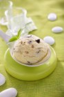 A scoop of walnut ice cream with basil on a spoon — Stock Photo
