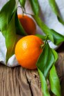 Fresh ripe tangerines on wooden table — Stock Photo