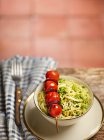 Capellini with pesto and a cherry tomato and chorizo ??skewer — Stock Photo