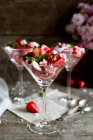 Fresh strawberries with pieces of meringues and mint — Stock Photo