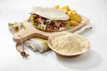 A doner kebab on a chopping board — Stock Photo