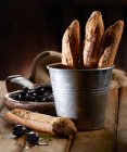 Olive baguettes in a metal bucket with black olives — Stock Photo