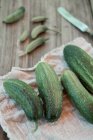 Fresh cucumbers on a towel — Stock Photo