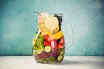 Infused water with fresh organic fruits and berries — Stock Photo