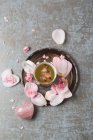 Rose blossom tea, rose quartz and rose petals — Stock Photo