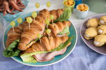 Savoury croissants with ham and grapes for a maritime themed party — Stock Photo