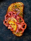Bruschetta with red and yellow tomatoes and red onions — Stock Photo