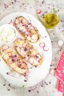 Bruschetta with Robiola cheese, olives, radishes and radish sprouts — Stock Photo