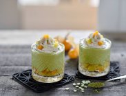 Vegan matcha cheesecake mousse with mango and physalis salad — Stock Photo