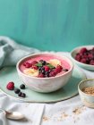 Smoothie bowl with raspberries, blueberries, bananas, fresh mint and sesame seeds — Stock Photo