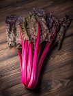 Red Swiss chard on a wooden background — Stock Photo