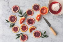 Blood orange slices with a citrus press — Stock Photo