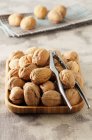 Whole Walnuts with Nut Crackers — Stock Photo