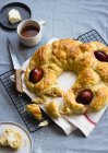 Greek Easter bread with boiled eggs, served with tea and butter — Stock Photo