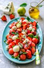 Salad from watermelon, melon, strawberry, basil and blue cheese with honey — Stock Photo