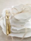 A Christmas table setting with a ribbon and gold cutlery — Stock Photo