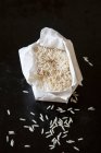 Basmati rice in a paper bag on a black background — Stock Photo