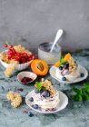 Mini pavlovas with whipped cream and fruit — Stock Photo