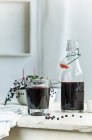 Homemade elderberry juice in a bottle and a glass — Stock Photo
