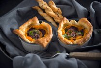 Puff pastry quiche with sweet potatoes, violet potatoes and shallots, vegan — Stock Photo