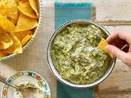 Spinach Artichoke Dip with Tortilla Chips — стокове фото