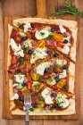 Pizza with mozzarella, tomatoes, ham, blueberries, rosemary, oregano and thyme — Stock Photo