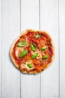 A pizza with mozzarella and basil (seen from above) — Stock Photo