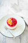 Cream cheese and redcurrant tartlet with a pink sponge finger base — Stock Photo