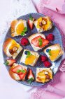 Süße Snacks mit verschiedenen Früchten auf Brot mit Frischkäse — Stockfoto