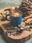 Rich winter hot chocolate with cinnamon sticks and walnuts — Stock Photo