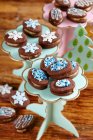 Chocolate biscuits filled with marzipan with winter theme decorations — Stock Photo