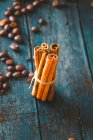 Coffee beans and cinnamon sticks on wood — Stock Photo