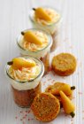 Carrot muffins with cream cheese and marzipan carrots in mason jars for Easter brunch — Stock Photo