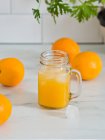 Fresh orange juice in jar — Stock Photo