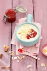 Milk soup with millet flakes and coconut and raspberry jam — Stock Photo